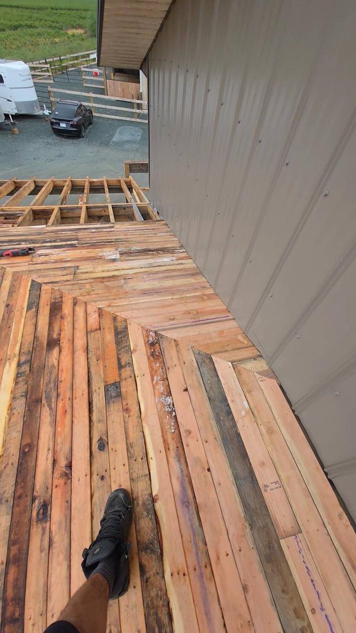 Cedar deck boards laid against the metal wall
