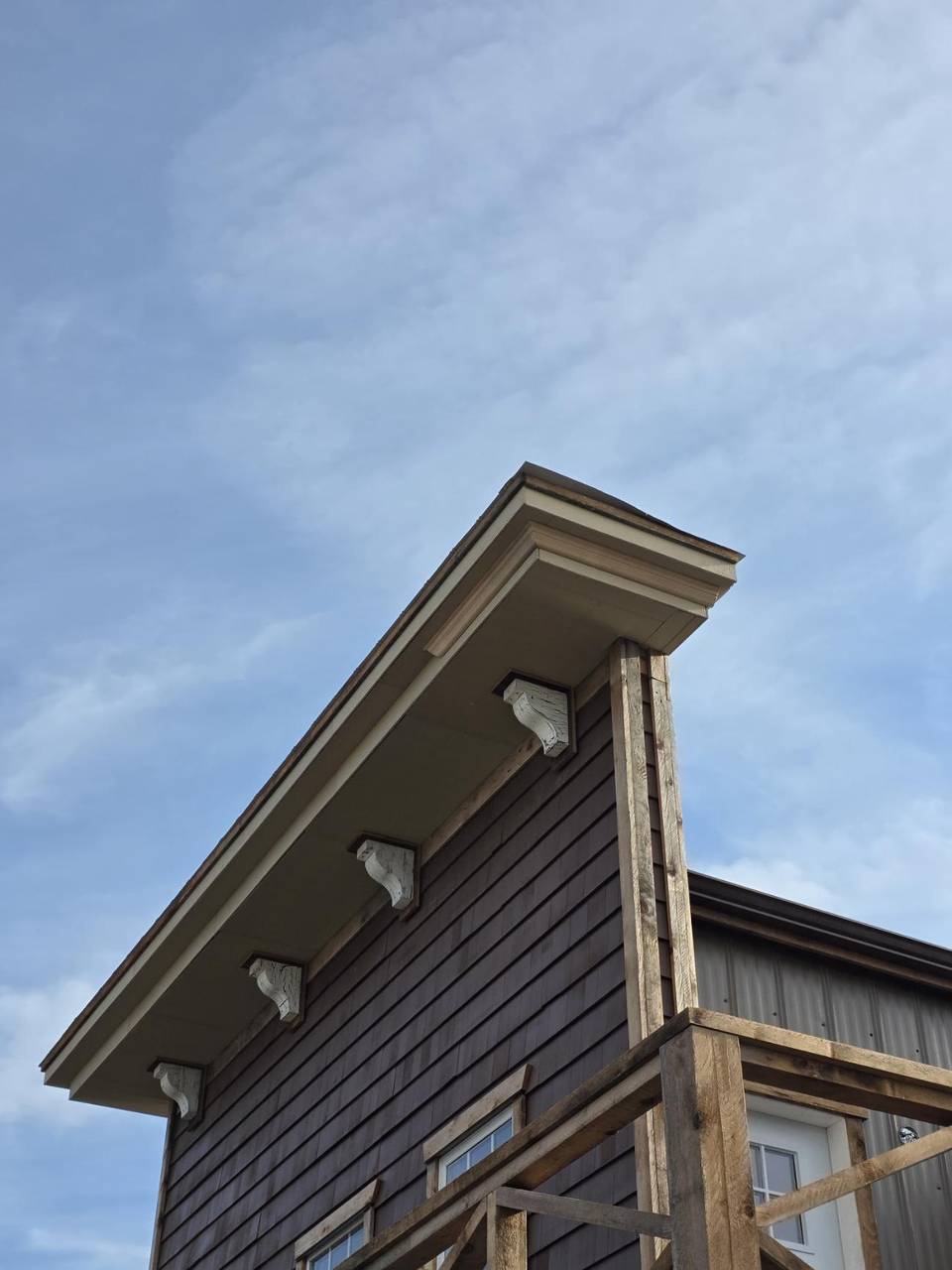 Carved corbels under the eave of the false front