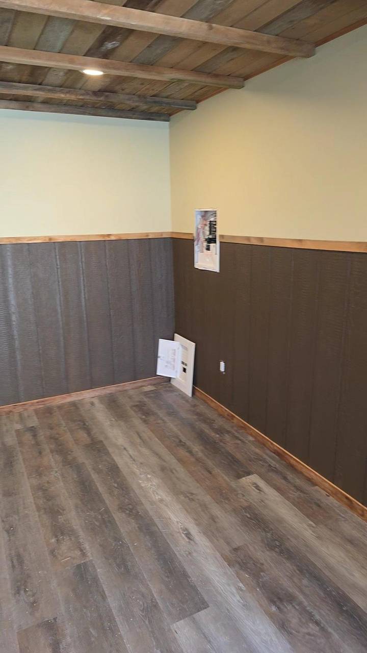 Two-tone wainscot turning the corner under a wood ceiling