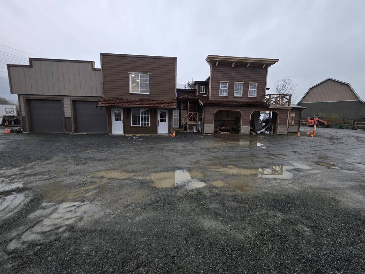 The street of false fronts, garage bays on the left and a balcony on the right