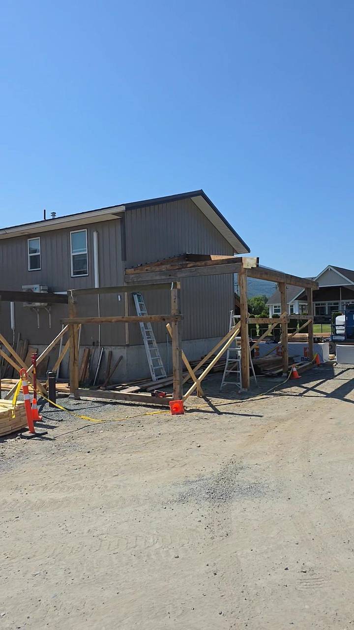 Timber porch frame set in front of the sided house