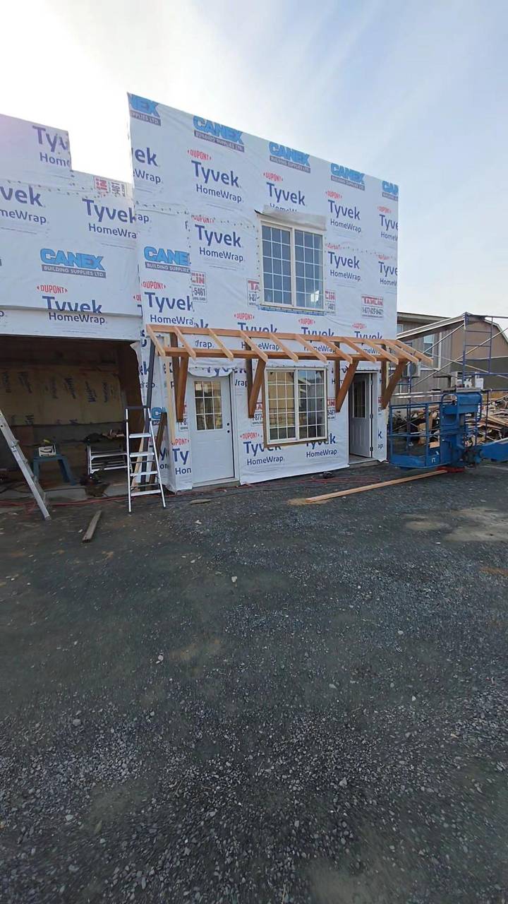 Addition wrapped, porch posts set beside the doors