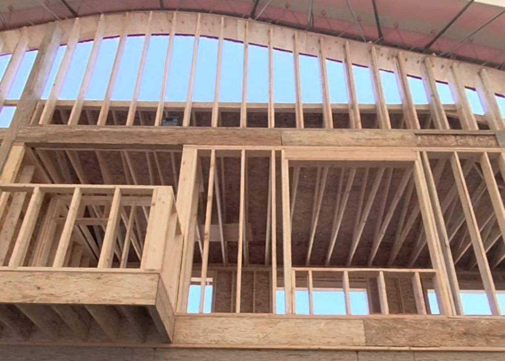 Second-floor balcony and window openings framed in the arena wall