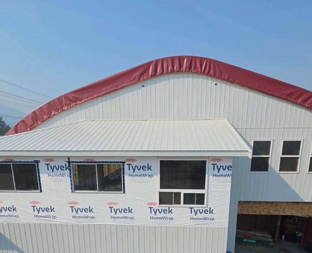 Arena wall from the lift, metal below and house wrap around the windows