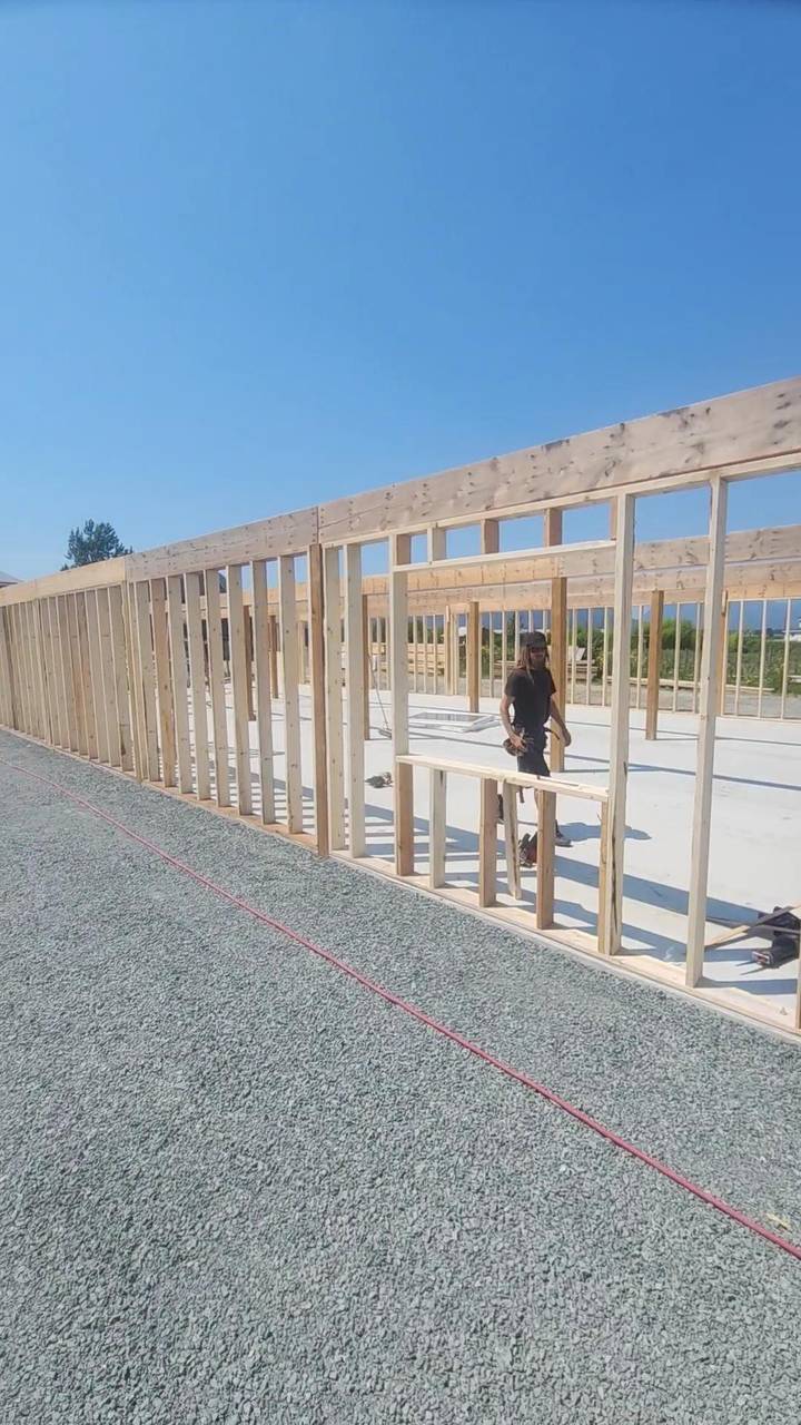 Barn wall framed in studs along the slab
