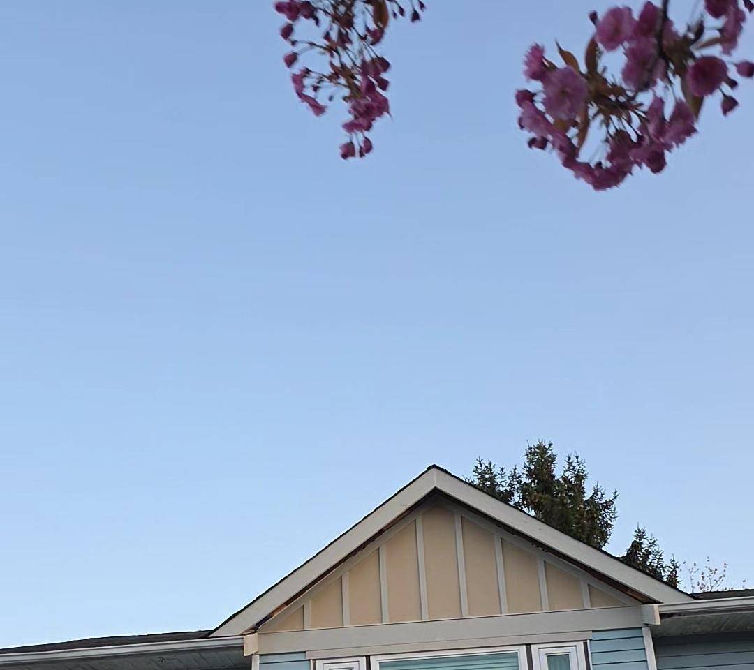 Light blue lap siding and a board gable on a finished house