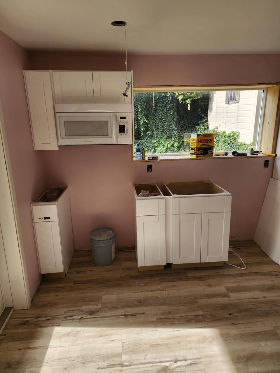 Cabinet boxes set under a new window, counters not on yet