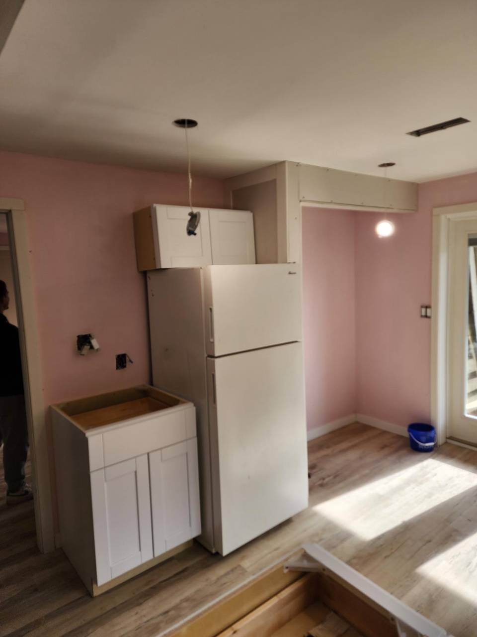 Cabinets and a fridge going in at the start of a kitchen renovation