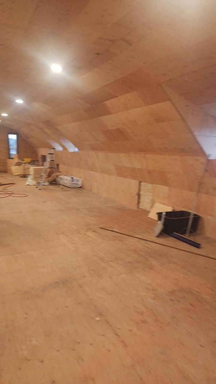 Plywood loft ceiling curving down to the knee wall