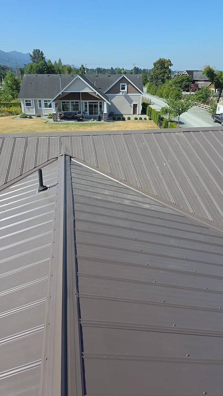 Finished metal roof valley with a vent pipe