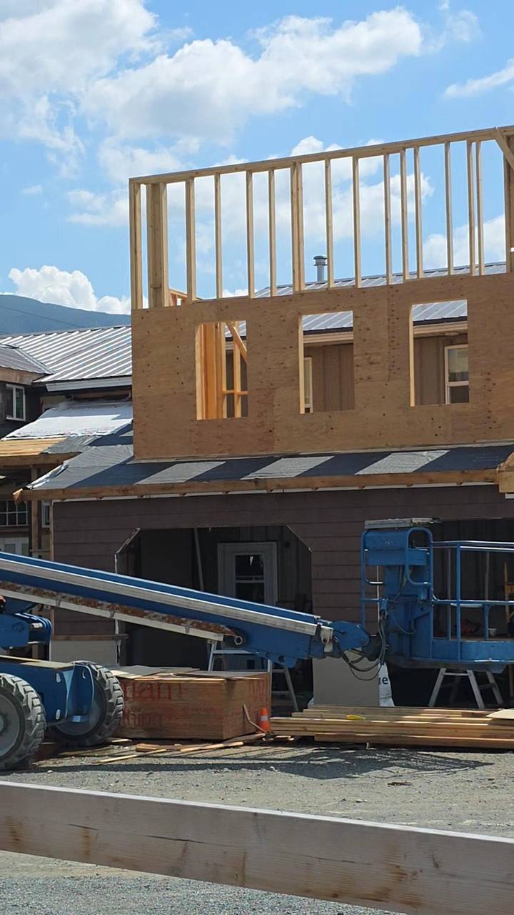 Second storey framed and sheathed, window openings cut, sitting over the first floor