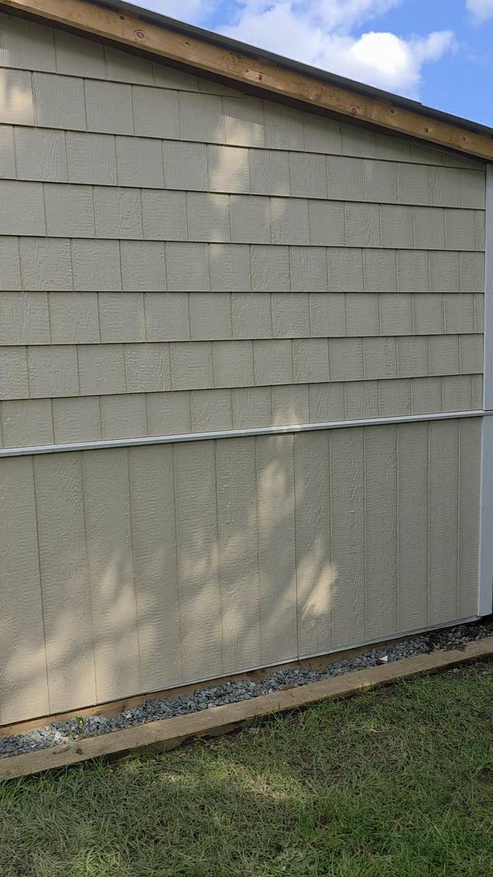 Finished beige siding, shingles above the belt and board below