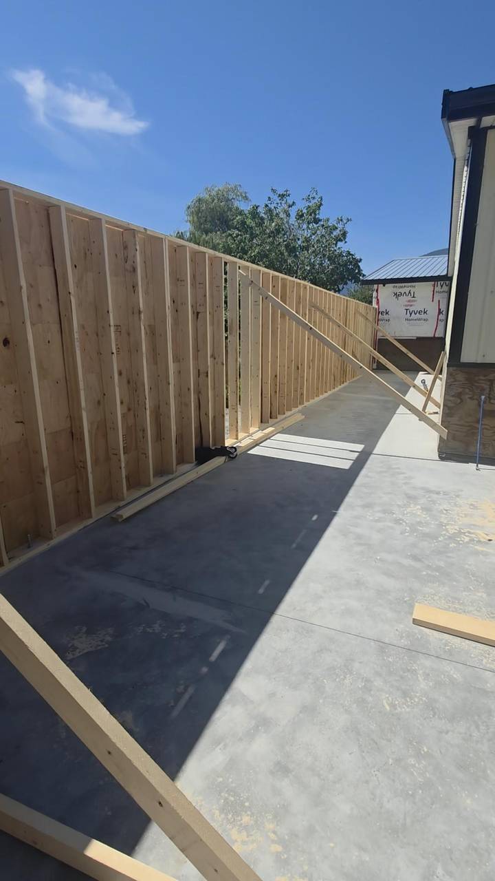 A long stud wall braced along a concrete slab