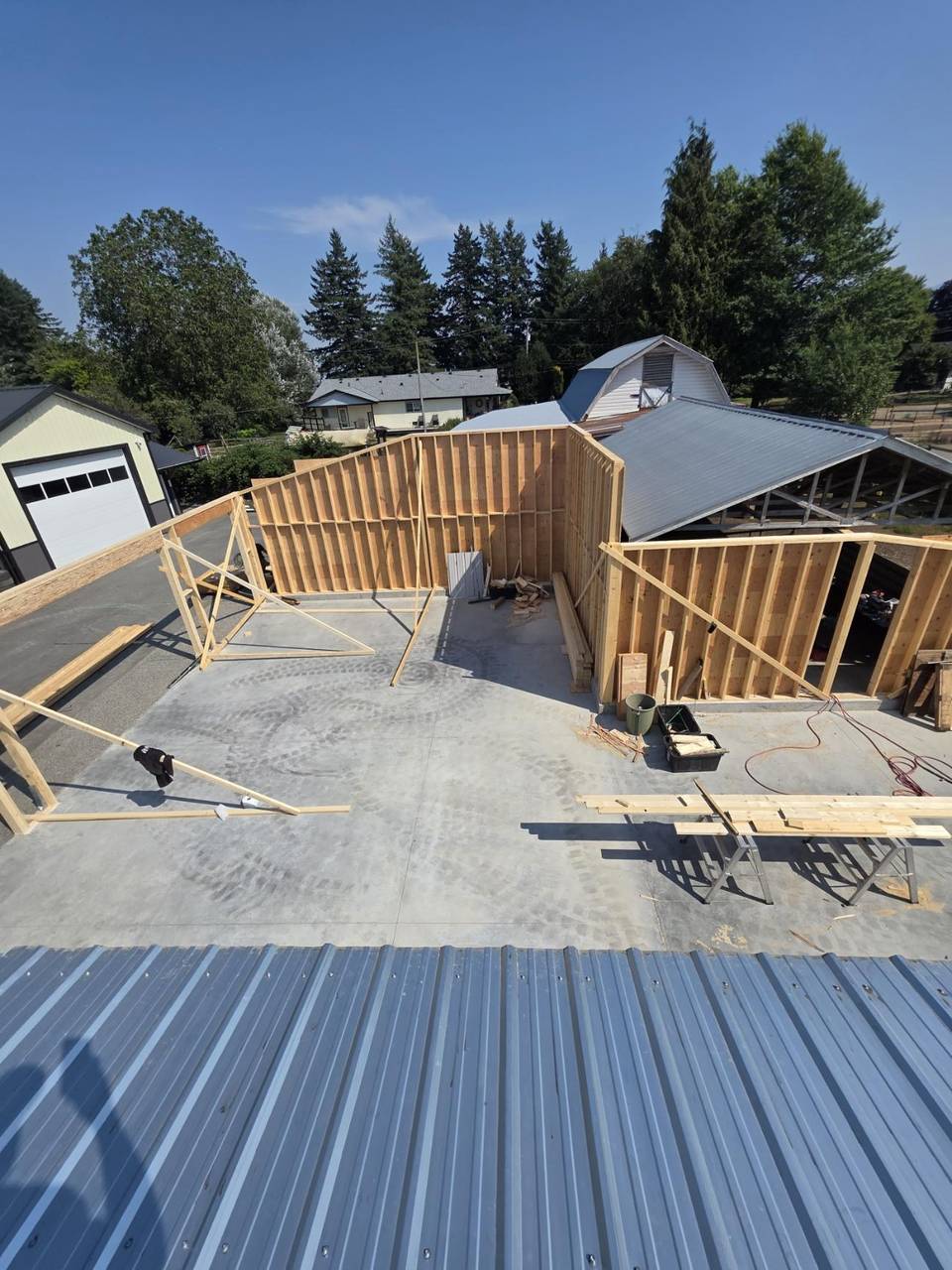 Stud walls standing on a slab, seen from the metal roof