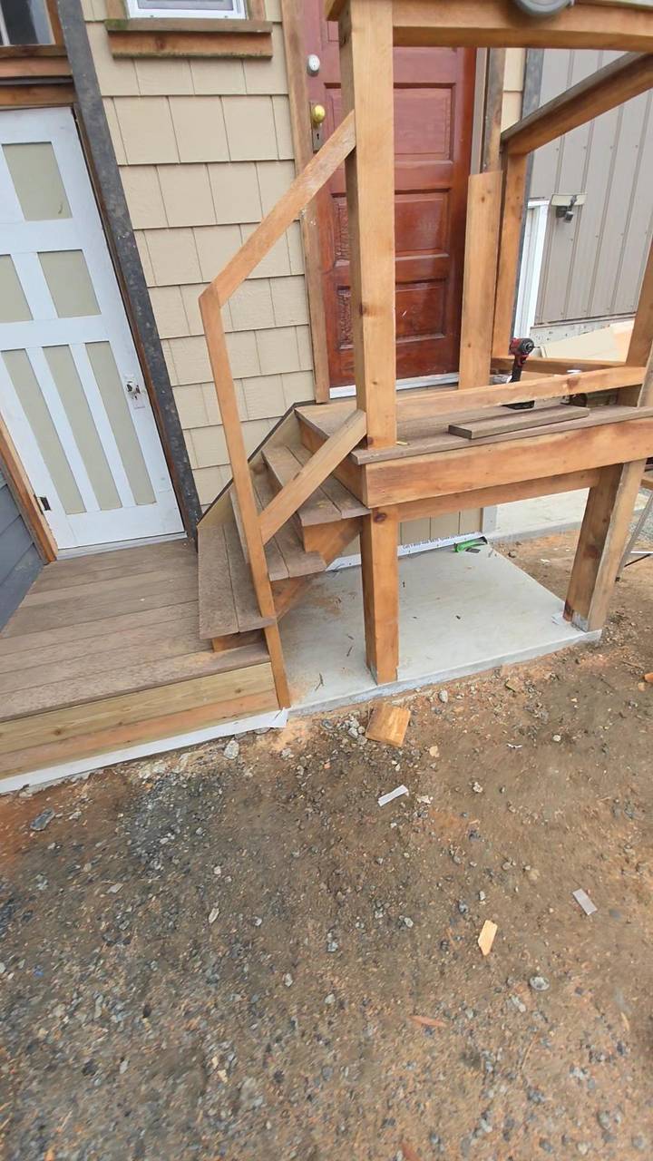 Wood stairs and a landing framed up to a new door
