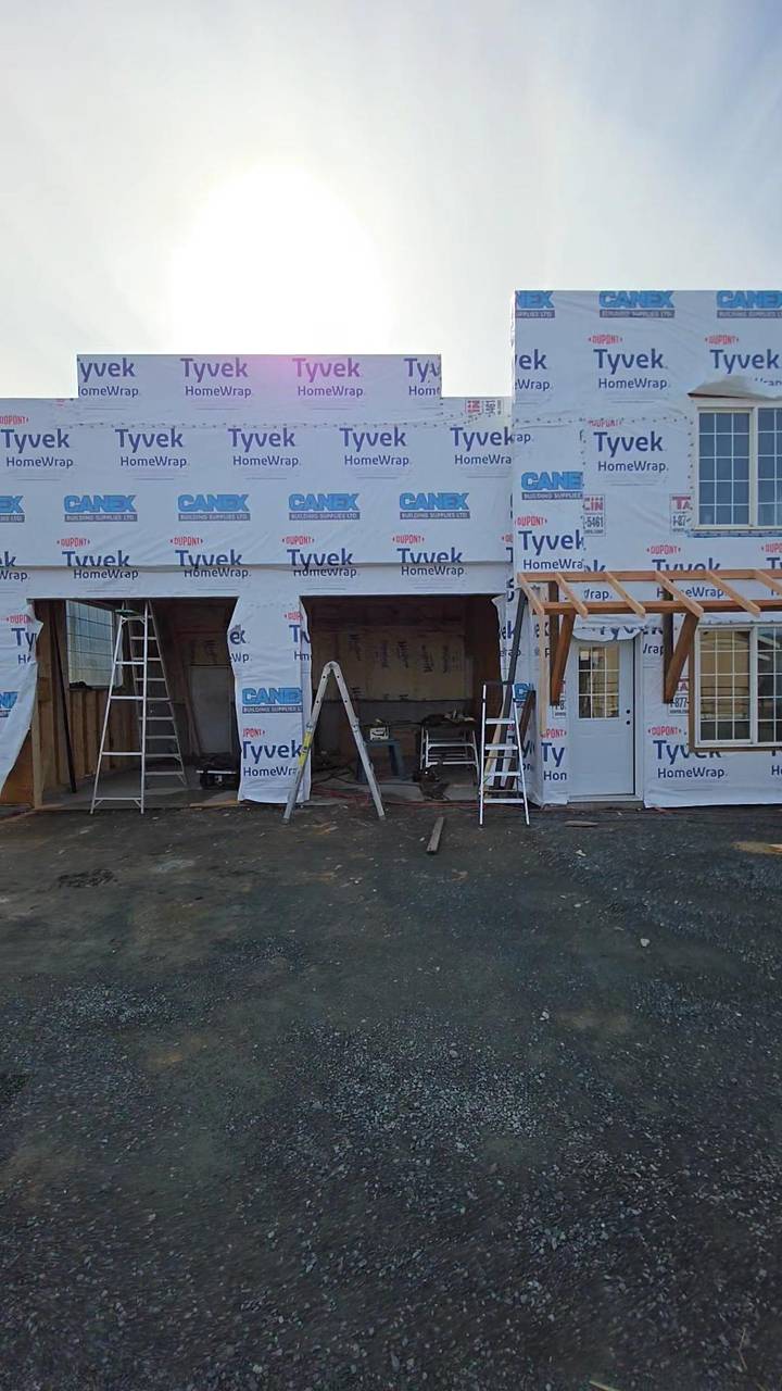 Open framed bays on a wrapped house, porch posts going up beside the door